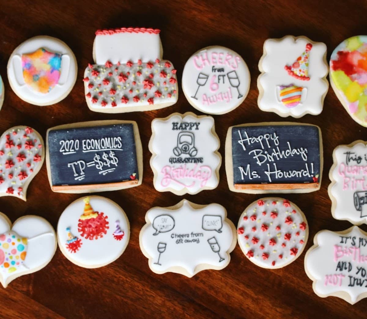 A white bakery tray holds an assortment of pastries, including a sugar doughnut, hot dog bun, and savory pork floss bread in front of a display case.
